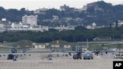 In this Dec. 17, 2009 photo, U.S. military airplanes and helicopters sit on the airstrip at Futenma Marine Corps Air Station surrounded by houses in Ginowan, Okinawa, Japan.