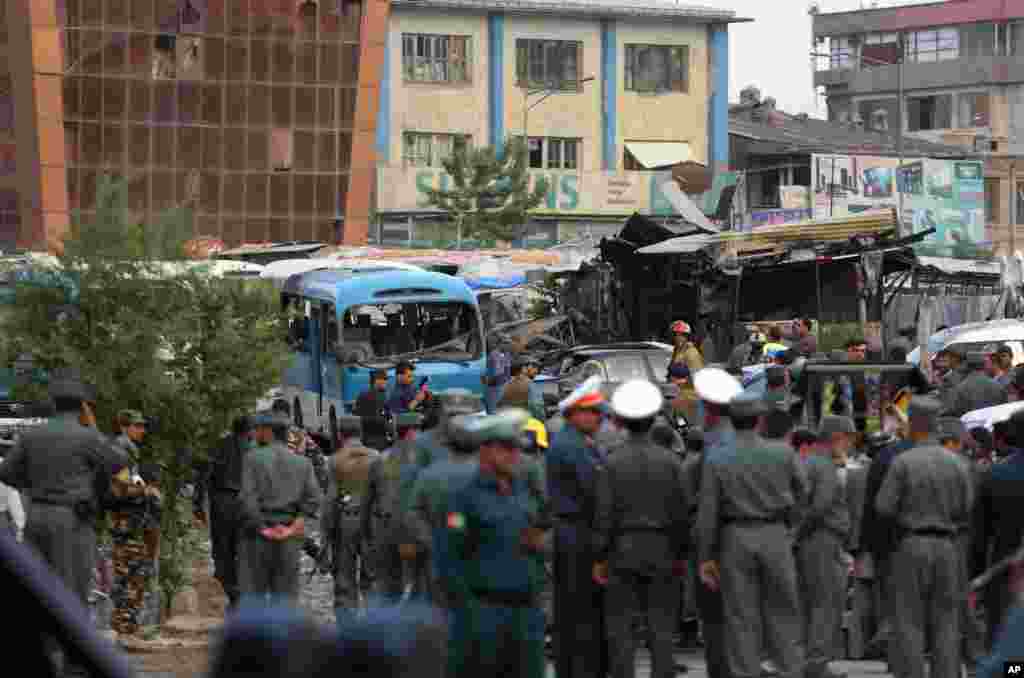 Afghan security forces inspect the site of a suicide bombing that killed several people in Kabul, May 19, 2015. 