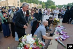 FILE - Republican gubernatorial candidate, Ed Gillespie, front left, waits to place a flower on an impromptu memorial for Nabra Hassanen, who was killed over the weekend in a road rage incident, prior to the start of a vigil in honor of Nabar on Wednesday, June 21, 2017, in Reston, Virginia.