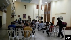 In this Aug. 21, 2015, photo, people helped by the San Egidio Church attend a prayer service in Havana, Cuba.