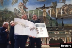 A 1:1 scale photographic book depicting Sistine Chapel is seen during a news conference in the Sistine Chapel, the Vatican, Feb. 24, 2017.