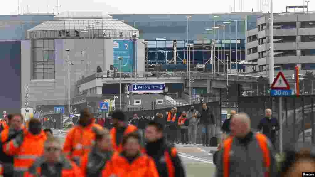 人们撤离布鲁塞尔Zavantem国际机场的爆炸现场。（2016年3月22日）