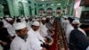 Myanmar Muslims pray at a mosque during the festival of Eid al-Fitr on the outskirts of Yangon, Myanmar Friday, Aug 9, 2013. (AP Photo/Khin Maung Win)