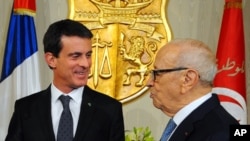 Tunisian President Beji Caid Essebsi, right, greets French Prime Minister Manuel Valls at the Presidential Palace in Carthage near Tunis, Tunisia, Nov. 28, 2016.