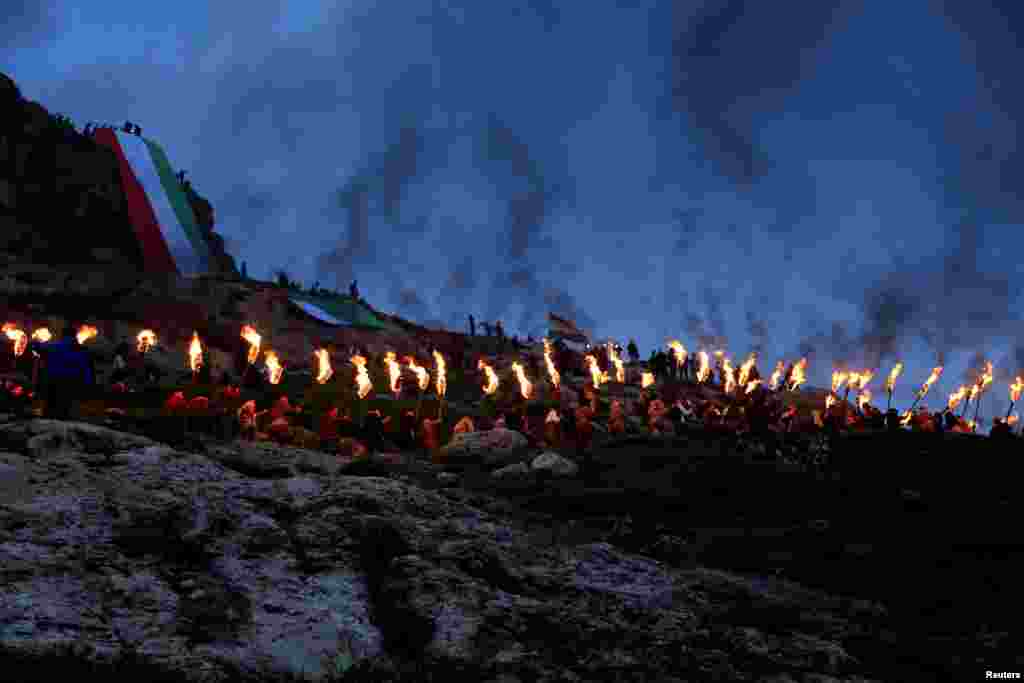 Iraqi Kurdish people carry fire torches as they celebrate Nowruz Day, a festival marking their spring and new year, in the town of Akra, March 20, 2017.