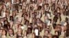 FILE - Multiple pictures of Baha'i religious leaders arrested in Iran are seen during a protest at Copacabana Beach in Rio de Janeiro, June 19, 2011.