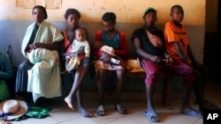 In this photo taken Thursday, March 21, 2019, mothers wait to have their babies vaccinated against measles, at a healthcare center in Larintsena, Madagascar. (AP Photo/Laetitia Bezain) 