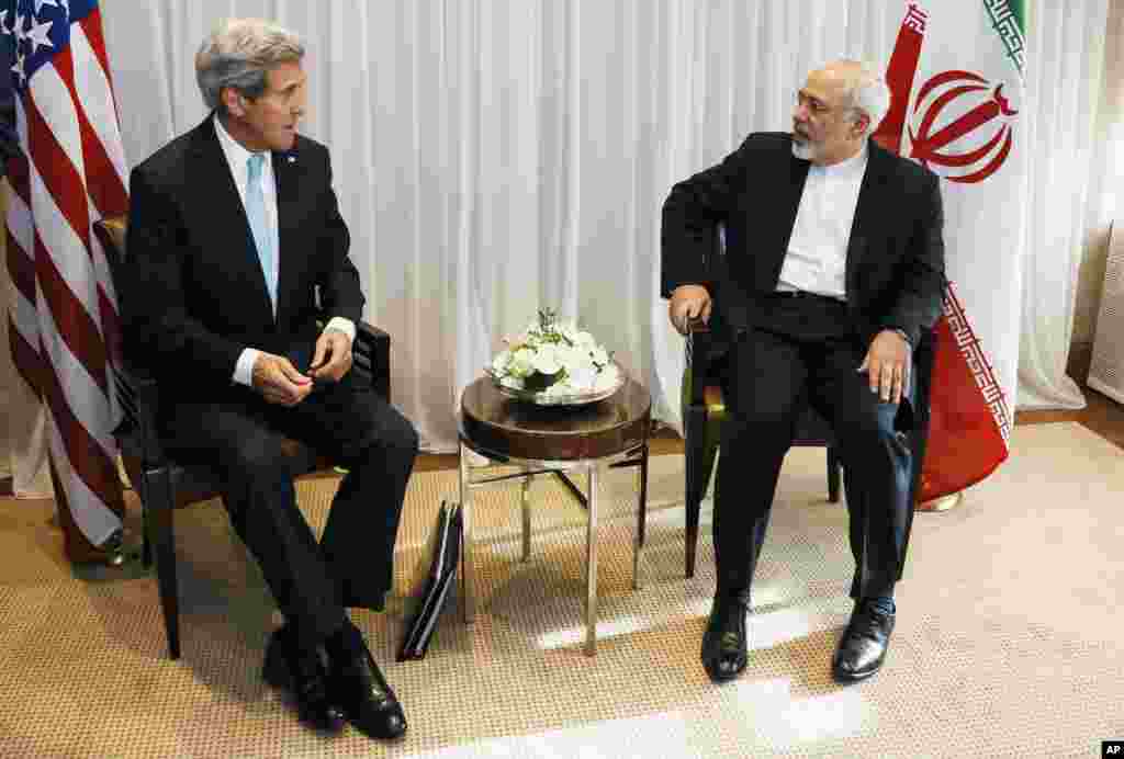 U.S. Secretary of State John Kerry chats with Iranian Foreign Minister Mohammad Javad Zarif before a meeting in Geneva, Switzerland, Jan. 14, 2015.