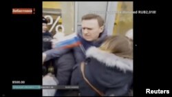 A still image taken from a video footage shows Russian opposition leader Alexei Navalny being detained by Interior Ministry members during a rally for a boycott of a March 18 presidential election in Moscow, Russia, Jan. 28, 2018.