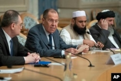 Russian Foreign Minister Sergey Lavrov, second left, speaks as he attends a conference on Afghanistan bringing together representatives of the Afghan authorities and the Taliban in Moscow, Russia, Nov. 9, 2018.
