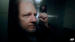 El fundador de WikiLeaks, Julian Assange, fue sacado de la corte, donde apareció acusado de haber saltado la fianza británica hace siete años, en Londres, el miércoles 1 de mayo de 2019. 