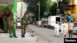 FILE - General Service Unit (GSU) members stand guard after assailants killed Muslim cleric Sheikh Mohammed Idris in Mombasa, Kenya, on June 10, 2014. 