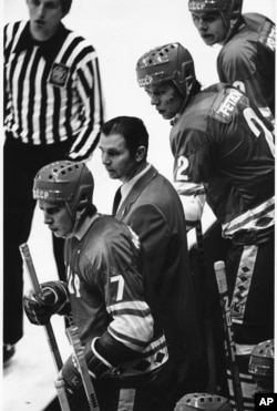 Soviet Coach Victor Tikhonov huddles with Soviet players Aleksei Kasatonov and Viacheslav Fetisof as the last minute counts down in the USA vs USSR ice hockey game in Lake Placid, N.Y. during the Winter Olympic Games on Feb. 22, 1980.