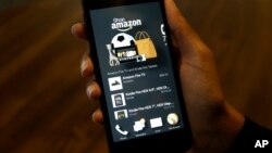FILE - A photo shows an app that links to online retailer Amazon.com on an Amazon Fire Phone, in Seattle, Washington, June 18, 2014. On Wednesday, the online shopping giant released Spark, its own social media network being described by some as cross between Instagram and Pinterest with a touch of e-commerce.