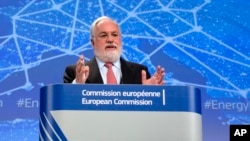 FILE - Miguel Arias Canete, EU climate change commissioner, speaks to reporters at EU headquarters in Brussels, Feb. 25, 2015. Canete says President Donald Trump's decision on pulling out of the Paris Agreement on climate change "has galvanized us," and that Europe and its partners "are ready to lead the way."