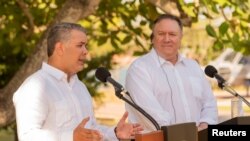 Colombian President Ivan Duque speaks as U.S. Secretary of State Mike Pompeo listens during a news conference at the guesthouse in Cartagena, Colombia, Jan. 2, 2019. 