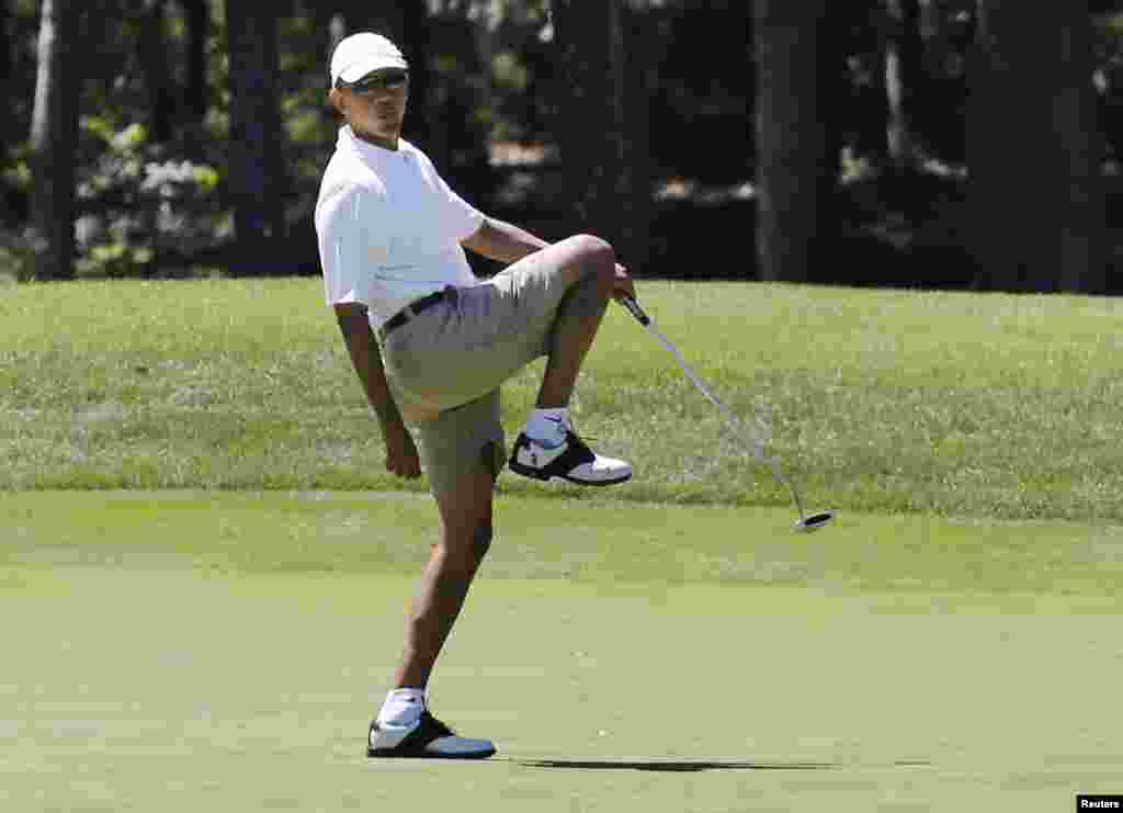 U.S. President Barack Obama reacts after missing a putt on the first green at the Farm Neck Golf Club at Oak Bluffs on Marthas Vineyard.