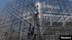 Workers are pictured at the construction site of the beach volleyball venue for 2016 Rio Olympics on Copacabana beach in Rio de Janeiro, Brazil, June 9, 2016. 