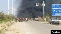 Still image shows a cloud of black smoke rising from vehicles in the distance in what is said to be Aleppo's outskirts, Syria April 15, 2017. 