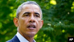 President Barack Obama speaks about developments in Iraq, Aug. 11, 2014, in Chilmark, Massachusetts, during his family vacation on the island of Martha's Vineyard.