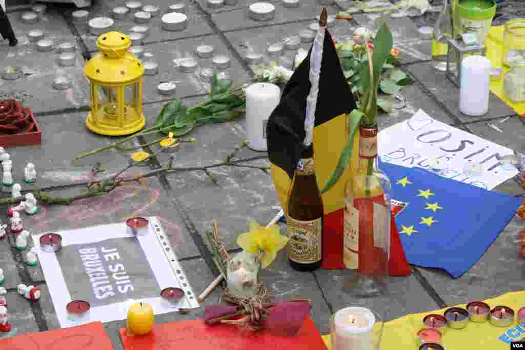 The public leaves offerings for those lost in the bombings. Many people are still missing as of 23 March, 2016, Brussels, Belgium. (H. Murdock / VOA)