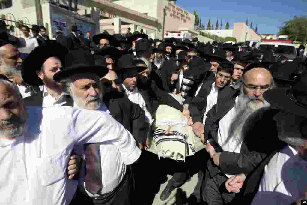 Ultra-Orthodox Jewish men carry the body of 17-year-old student Shalom Baadani during his funeral in Jerusalem,&nbsp;Nov. 7, 2014. 