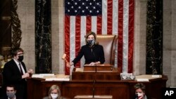 Speaker of the House Nancy Pelosi, D-Calif., gavels in the final vote of the impeachment of President Donald Trump, for his role in inciting an angry mob to storm the Congress last week, at the Capitol in Washington, Wednesday, Jan. 13, 2021. (AP Photo/J. Scott Applewhite)