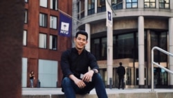 Nagorn Promma sits on the steps in front of NYU Stern School of Business.