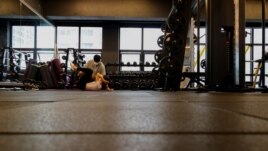 Gym member exercises at a fitness club in Seoul, South Korea, July 12, 2021. Kang Hyun-ku, a gym owner, questioned how it will be possible to control the music people listen to when they wear personal listening devices like earphones. (REUTERS/Heo Ran)
