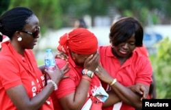 "#Bring Back Our Girls" campaigners console a fellow member who broke down in tears, as more towns in Nigeria come under attack from Boko Haram in Abuja, Nov. 3, 2014.