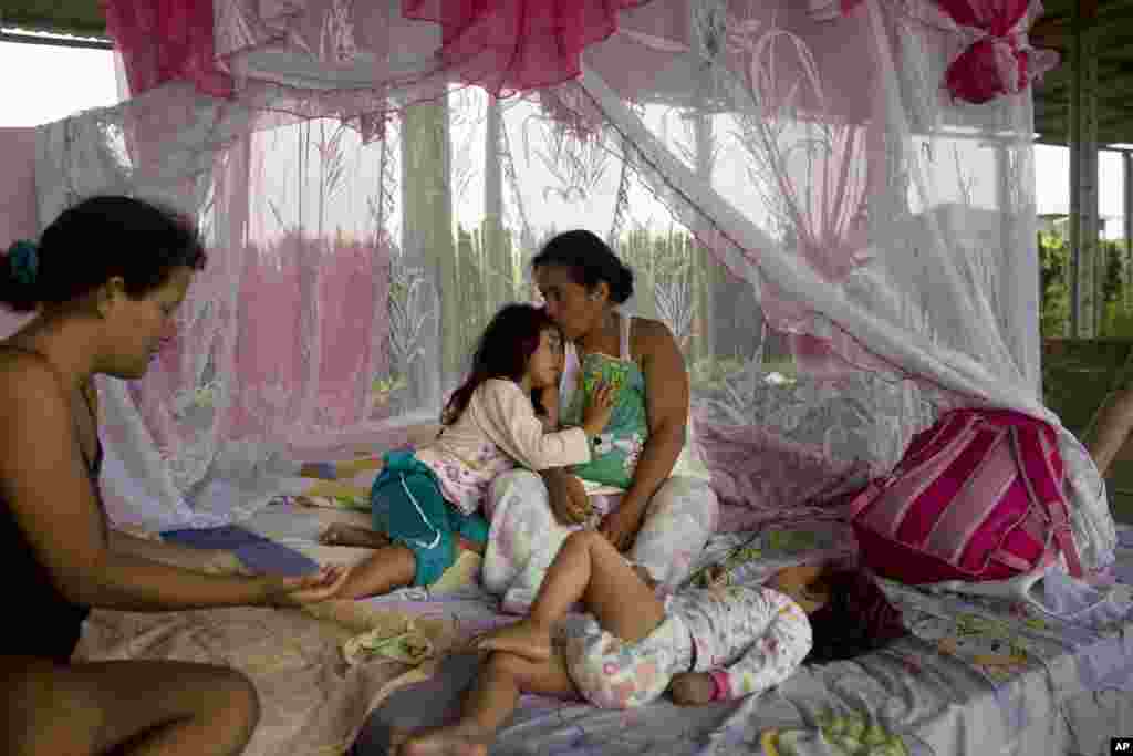 Tais Minga embraces her mother as they wake up inside a building normally used to store small fishing boats, where four families took shelter after losing their homes in the earthquake in Pedernales, Ecuador. Ecuadorians are sleeping outside and struggling to find food and water as aftershocks continue to rock towns flatted by Saturday&rsquo;s powerful earthquake.