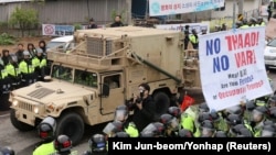 FILE - A U.S. military vehicle, which is a part of Terminal High Altitude Area Defense (THAAD) system, arrives in Seongju, South Korea, April 26, 2017. A South Korean official said Friday the decision to delay full deployment will ensure a democratic process.