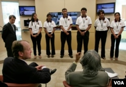 Students from Cisco Network Academy talk with former Indian President A. P. J. Abdul Kalam, (right, back to camera), while CEO John Chambers (seated left) and Cisco Asia Pacific President Owen Chan, (standing left) look on in Bangalore, India, in 2007. (AP/Aijaz Rahi)