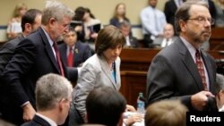 Director of Exempt Organizations for the Internal Revenue Service Lois Lerner (C) departs with her legal team after being excused from a House Oversight and Government Reform Committee hearing on targeting of political groups seeking tax-exempt status fro