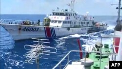 FILE - Screen grab shows the Chinese Coast Guard ship 46001 (L) chasing a Vietnamese vessel near to the site of the Chinese oil rig in the disputed waters in the South China Sea, off Vietnam's central coast. 