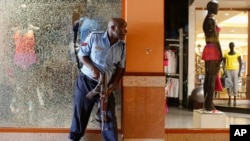 Police officer tries to secure area inside Westgate Shopping Centre after gunmen went on a shooting spree, Nairobi, Sept. 21, 2013.