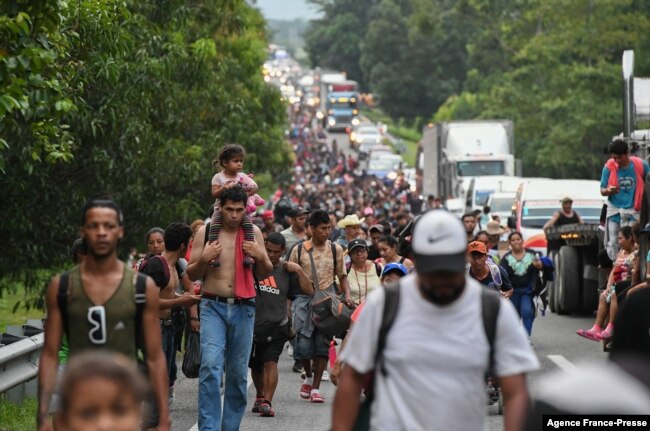 Migrants heading in a caravan to the US, walk towards Mexico City to request asylum and refugee status in Villa Comaltitlan, Chiapas State, Mexico, on October 28, 2021.