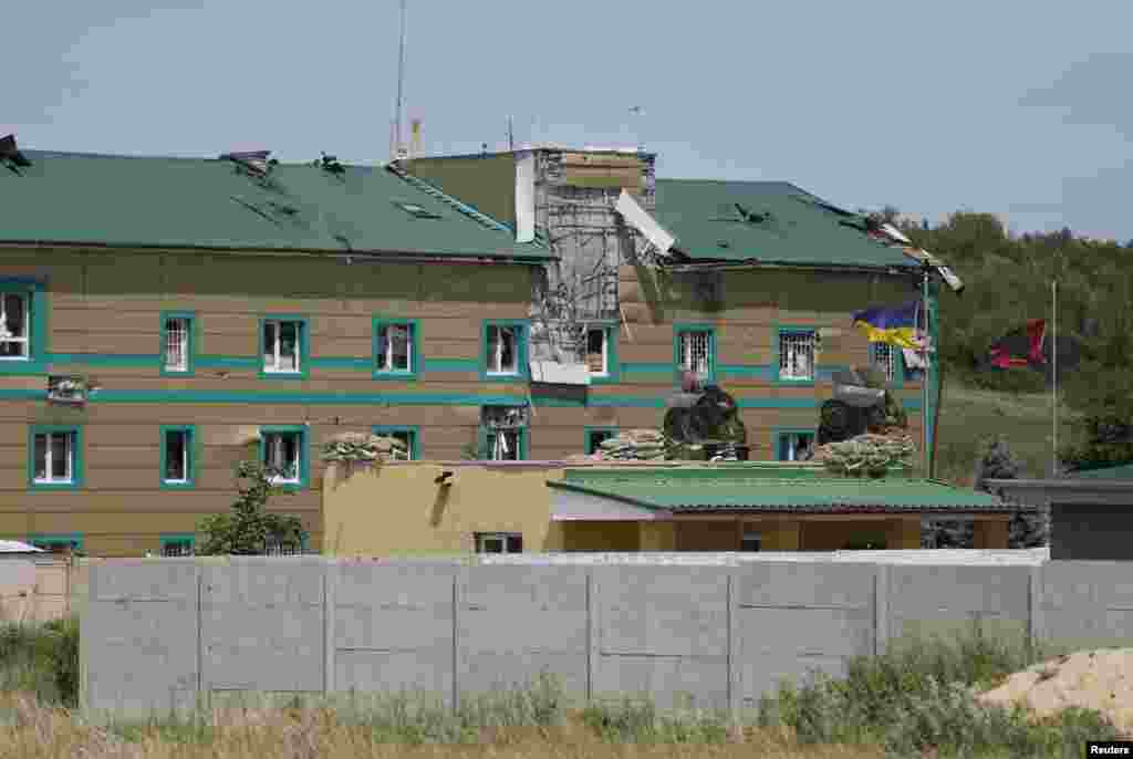 Damaged buildings are seen at a Ukrainian border guard camp, after what local residents say was an attack by pro-Russian separatists, on the outskirts of the eastern Ukrainian city of Luhansk June 3, 2014.