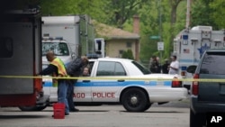 FILE - Police cordon off an area where a possible murder suspect has fired shots in Chicago. 