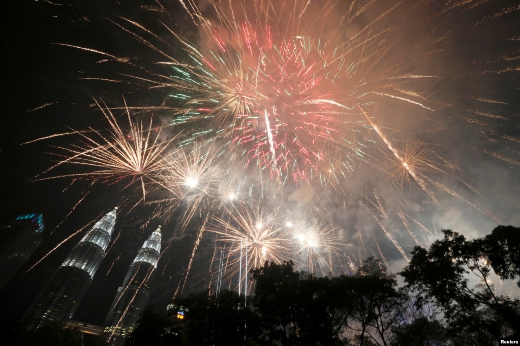 Fireworks explode near Petronas Twin Towers during New Year celebrations in Kuala Lumpur, Malaysia, Jan. 1, 2019. 