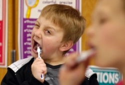 FILE: David Taylor, 9, gets into brushing his teeth after lunch in Moscow, Idaho, as part of a program started by Dentist Rich Bailey to help promote dental health. March 12, 2010.