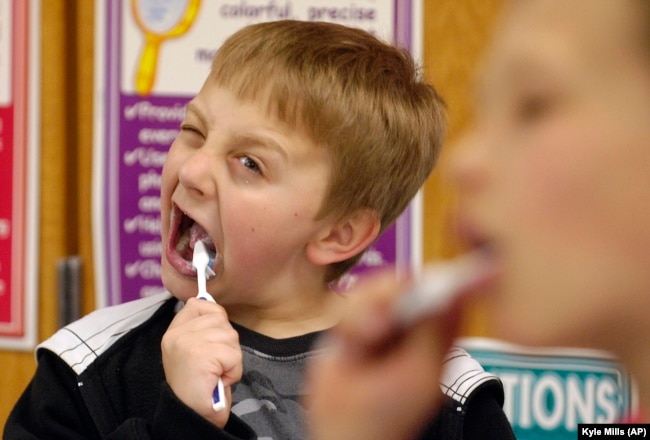 FILE: David Taylor, 9, gets into brushing his teeth after lunch in Moscow, Idaho, as part of a program started by Dentist Rich Bailey to help promote dental health. March 12, 2010.