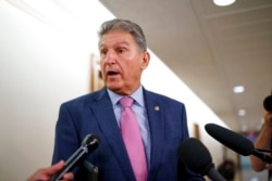 FILE - Sen. Joe Manchin, D-W.Va., talks to reporters at the Capitol in Washington, Oct. 5, 2021.