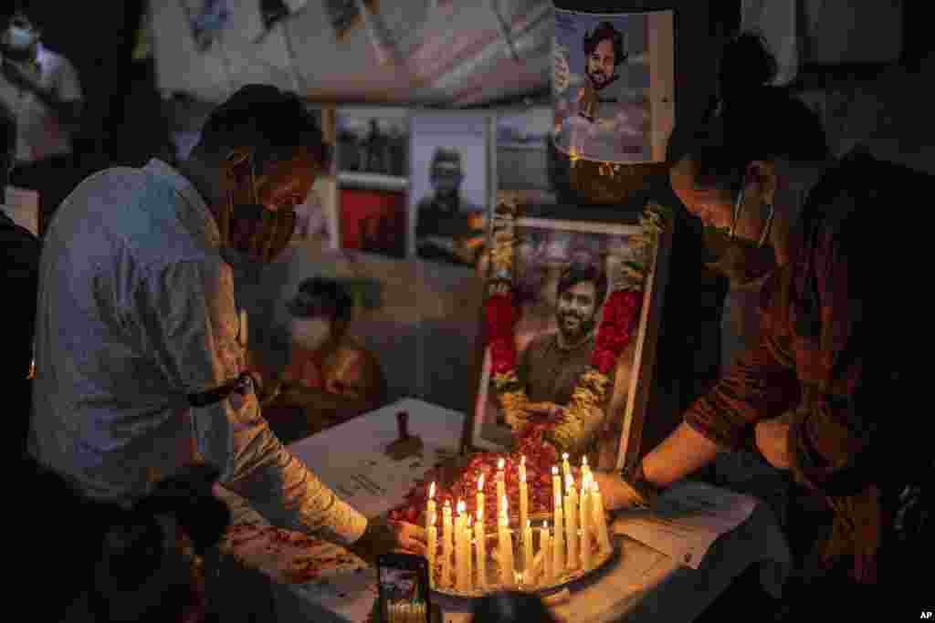 Journalists light candles and pay tribute to Reuters photographer Danish Siddiqui in New Delhi, India, July 17, 2021.&nbsp;The Pulitzer Prize-winning photographer was killed as he chronicled fighting between Afghan forces and the Taliban near a strategic border crossing.