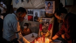 Journalists light candles and pay tribute to Reuters photographer Danish Siddiqui in New Delhi, India, Saturday, July 17, 2021.