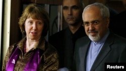 FILE - European Union foreign policy chief Catherine Ashton (L) and Iranian Foreign Minister Mohammad Javad Zarif (R) arrive at a news conference at the end of the Iranian nuclear talks in Geneva, Nov. 10, 2013.