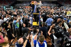 North Carolina coach Roy Williams helps cut down the net after the finals of the Final Four, April 3, 2017, in Glendale, Arizona.