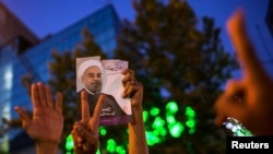 Supporters of moderate cleric Hassan Rouhani celebrate his victory in Iran's presidential election, Tehran, June 15, 2013.