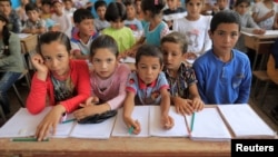 Children attend their first class immediately after they got registered at the school in Hazema North Raqqa, Syria, Aug. 21, 2017. 