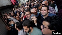 People attend the funeral of Egyptian police officer Mahmoud Abou El Yazied who was killed in a blast, in Cairo, Egypt, Feb. 19, 2019.